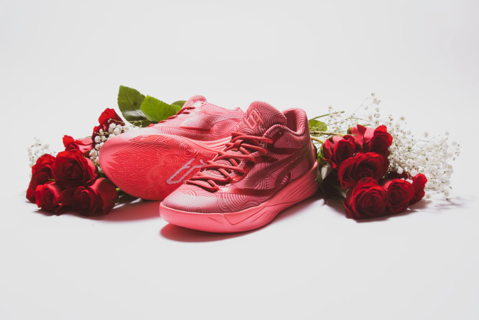 Breanna Stewart's pink and red PUMA sneakers next to roses.